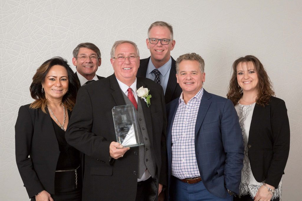 Scott Jones and members of Donaldson holding the Alvin L. Sussman award